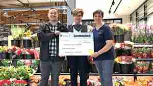 Die stellvertretende Marktleiterin des E-Centers Weserstraße Andrea Wöhler (Mitte) übergibt den Spendenscheck an Gundula Brügger und Felix Urbansky vom Tierheim Burgdorf.